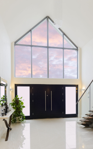 Stunning modern home with Apex window above the aluminium front door.
