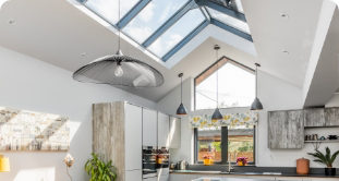 Kitchen extension with roof lantern and low hanging ceiling lights.