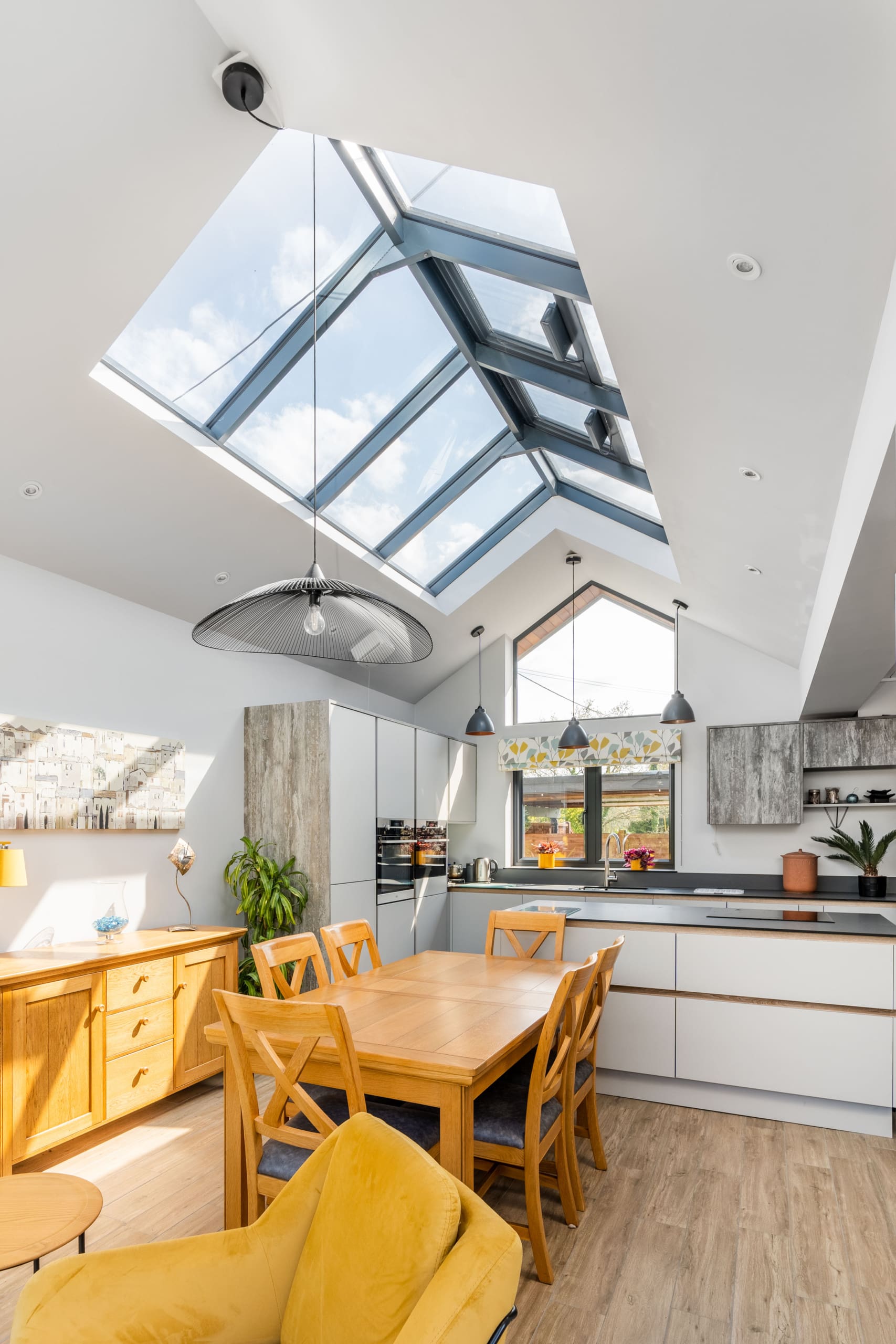 Kitchen extension with modern oak furniture and roof lantern.