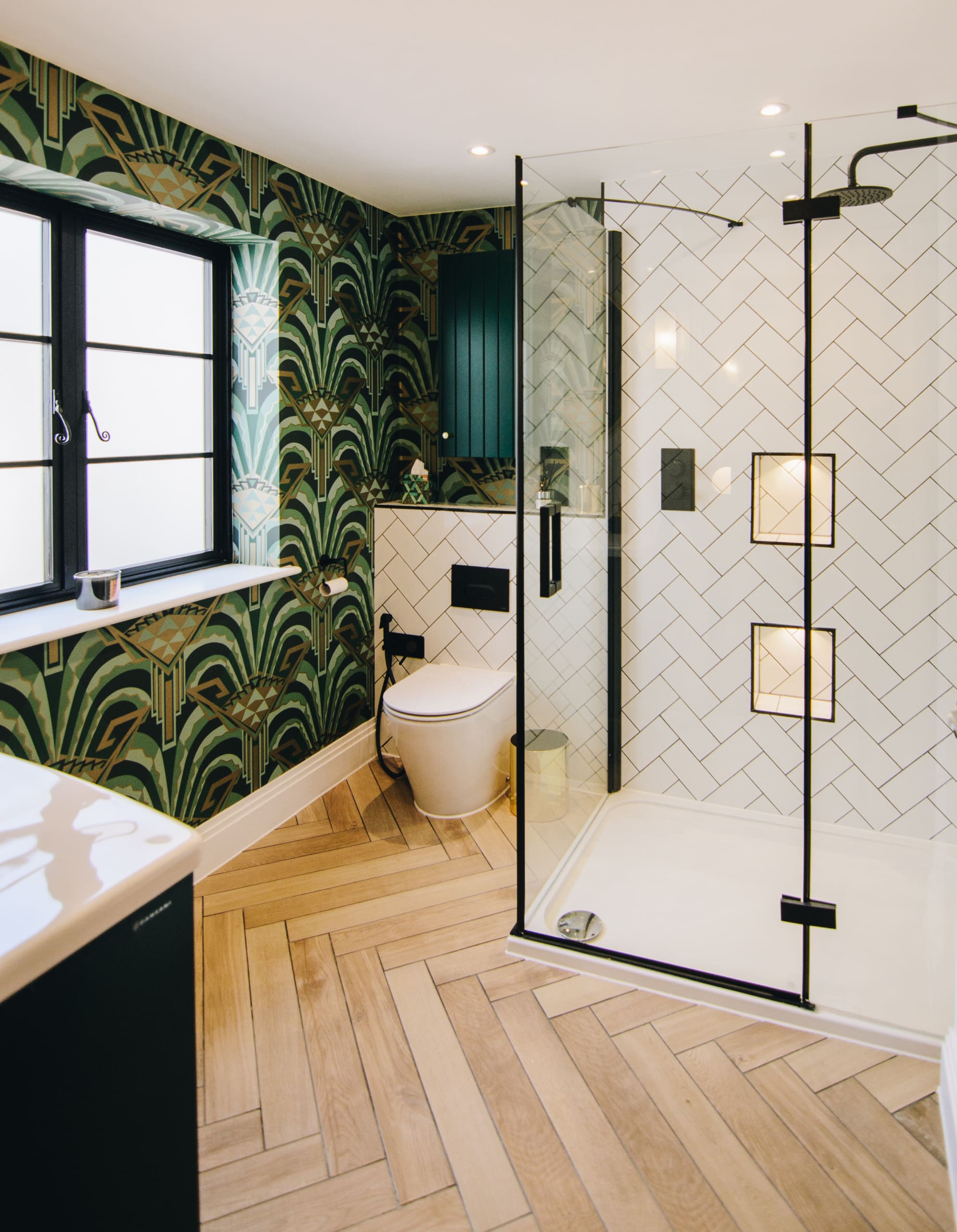 Art deco style bathroom with herringbone wooden floor.