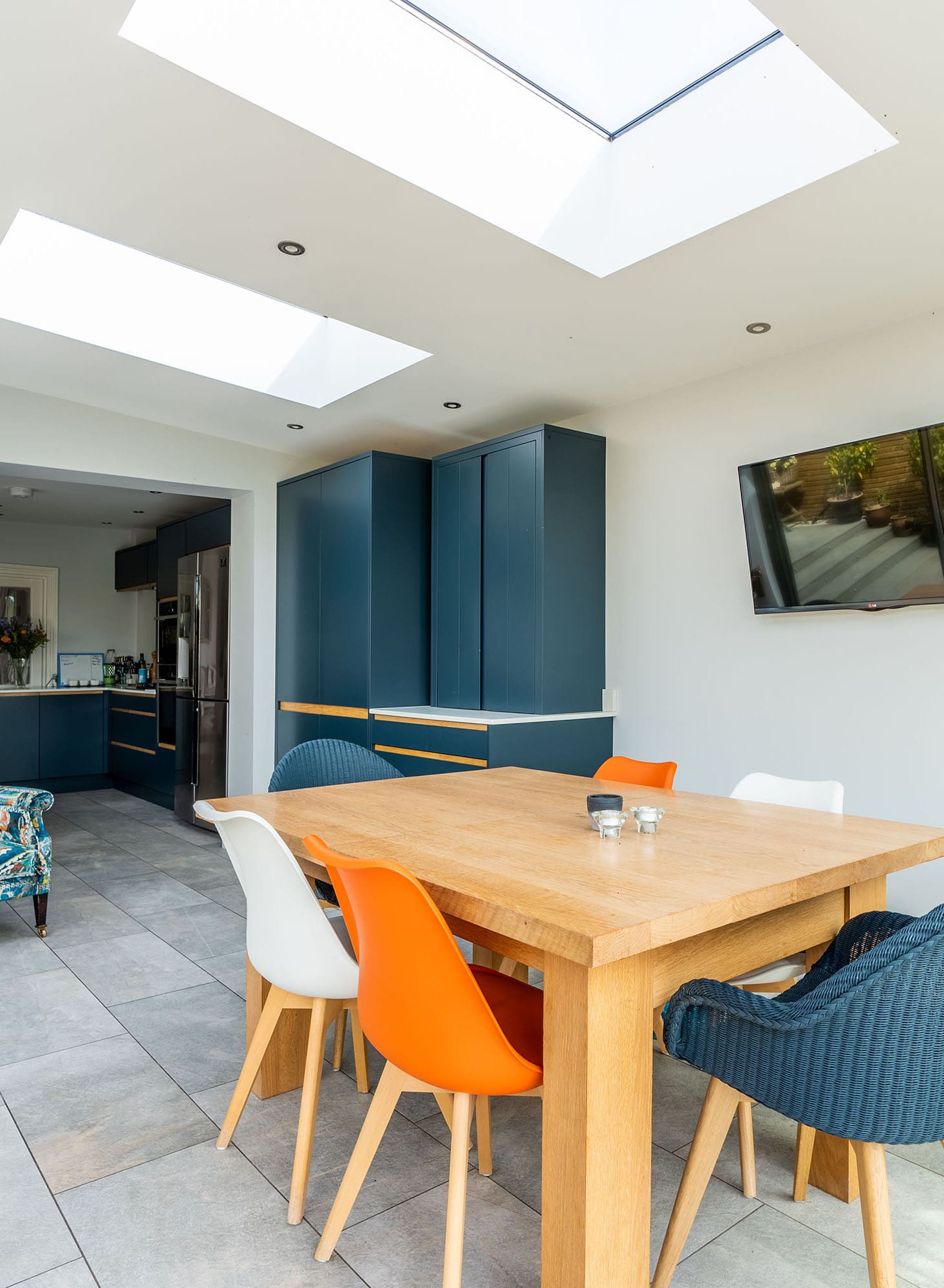 Interior of a modern kitchen diner extension with sliding glass doors and roof lantern.