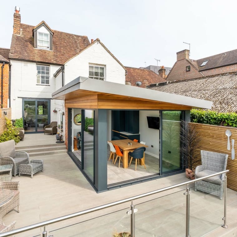 Mono pitched kitchen diner extension featuring timber fascias and sliding glass patio doors.