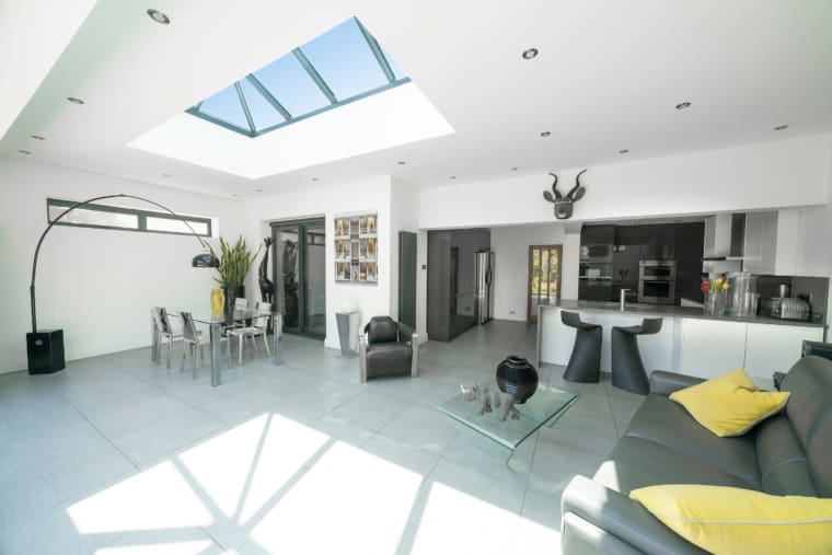 Open plan living room, dining room and kitchen with rooflight.