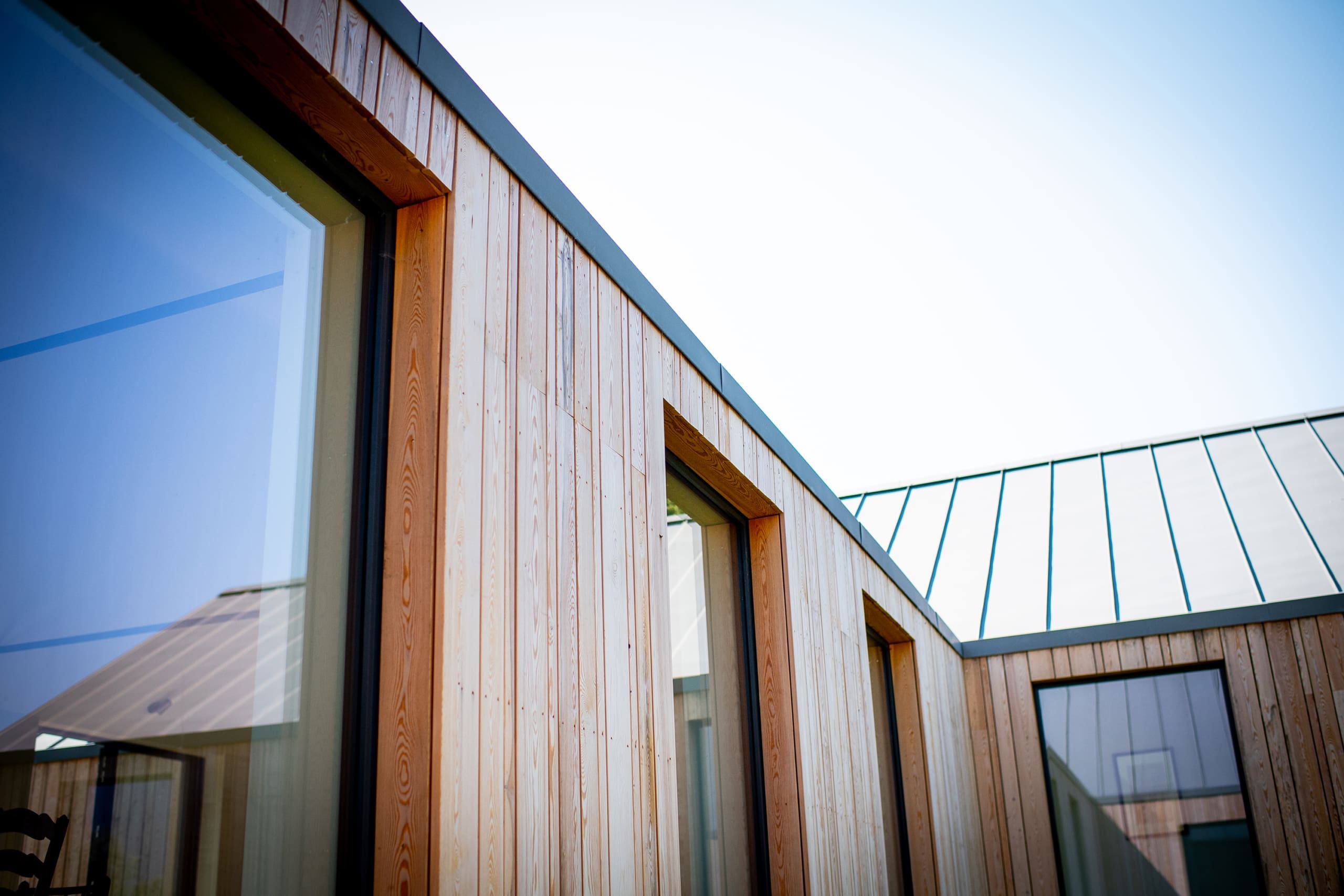 Wooden clad building with aluminium windows.