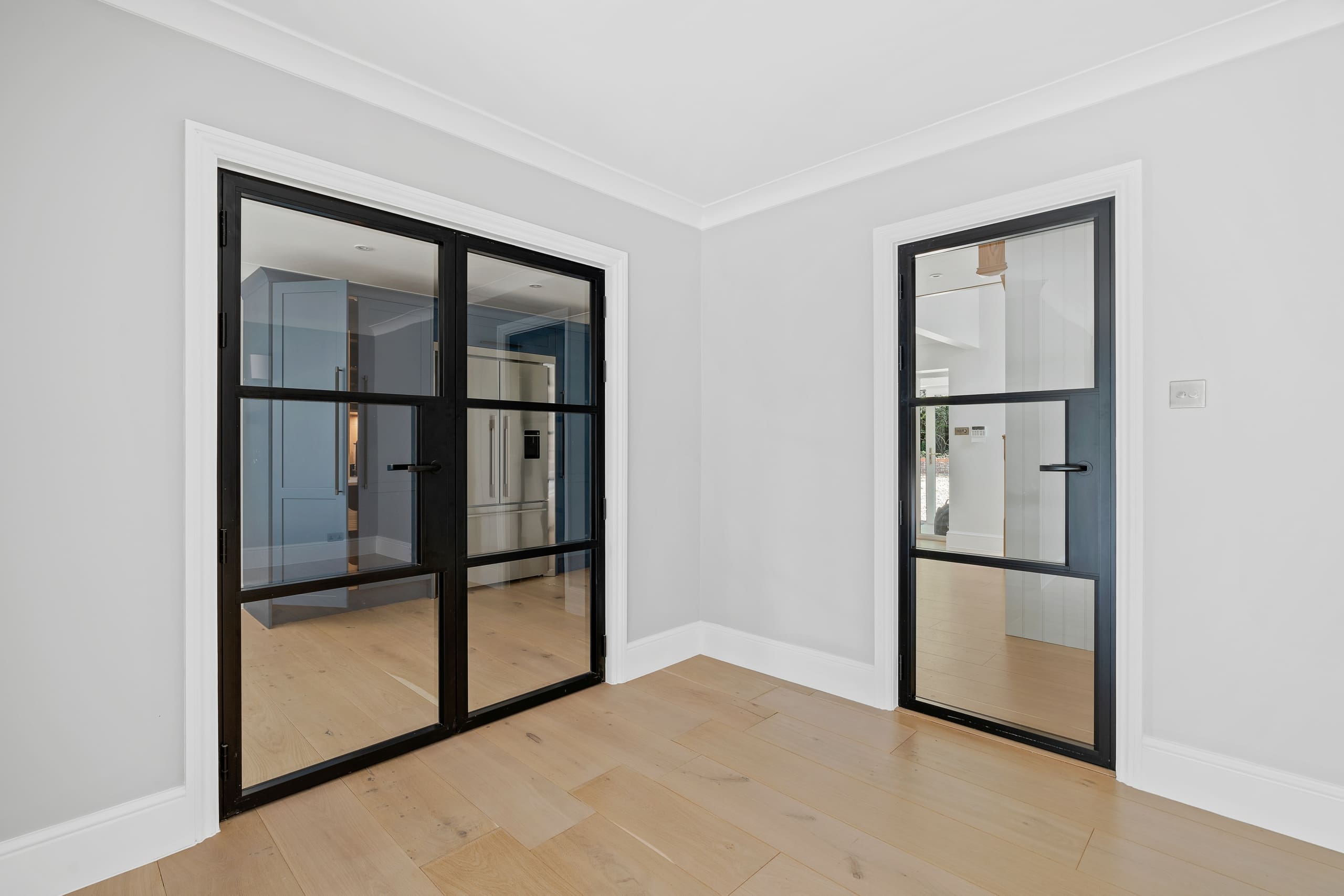 Aluminium black internal french doors and single door to modern home.