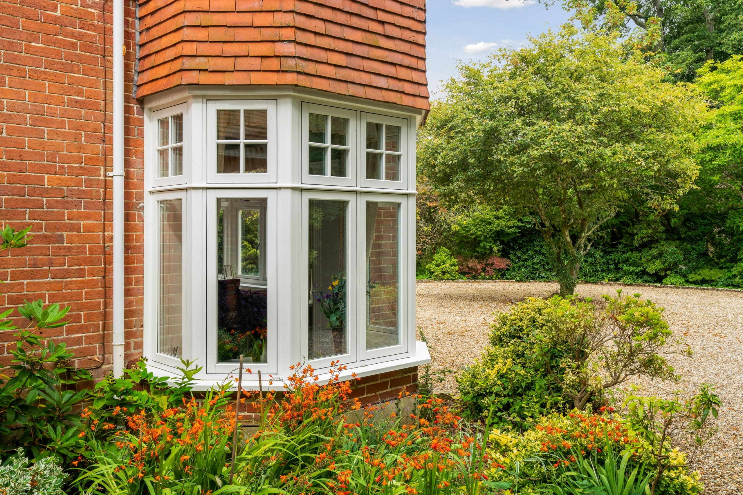 Exterior of a bay window to a substantial home using the Flush product range from Evolution.