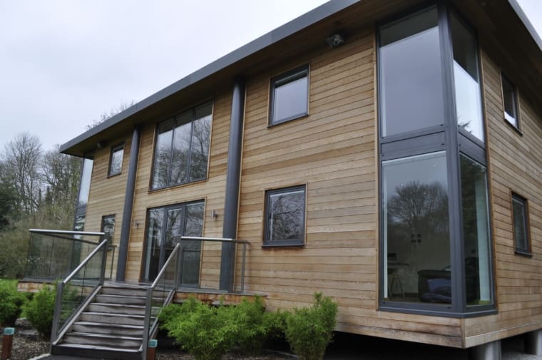 Modern property with wooden cladding and aluminium windows and doors.