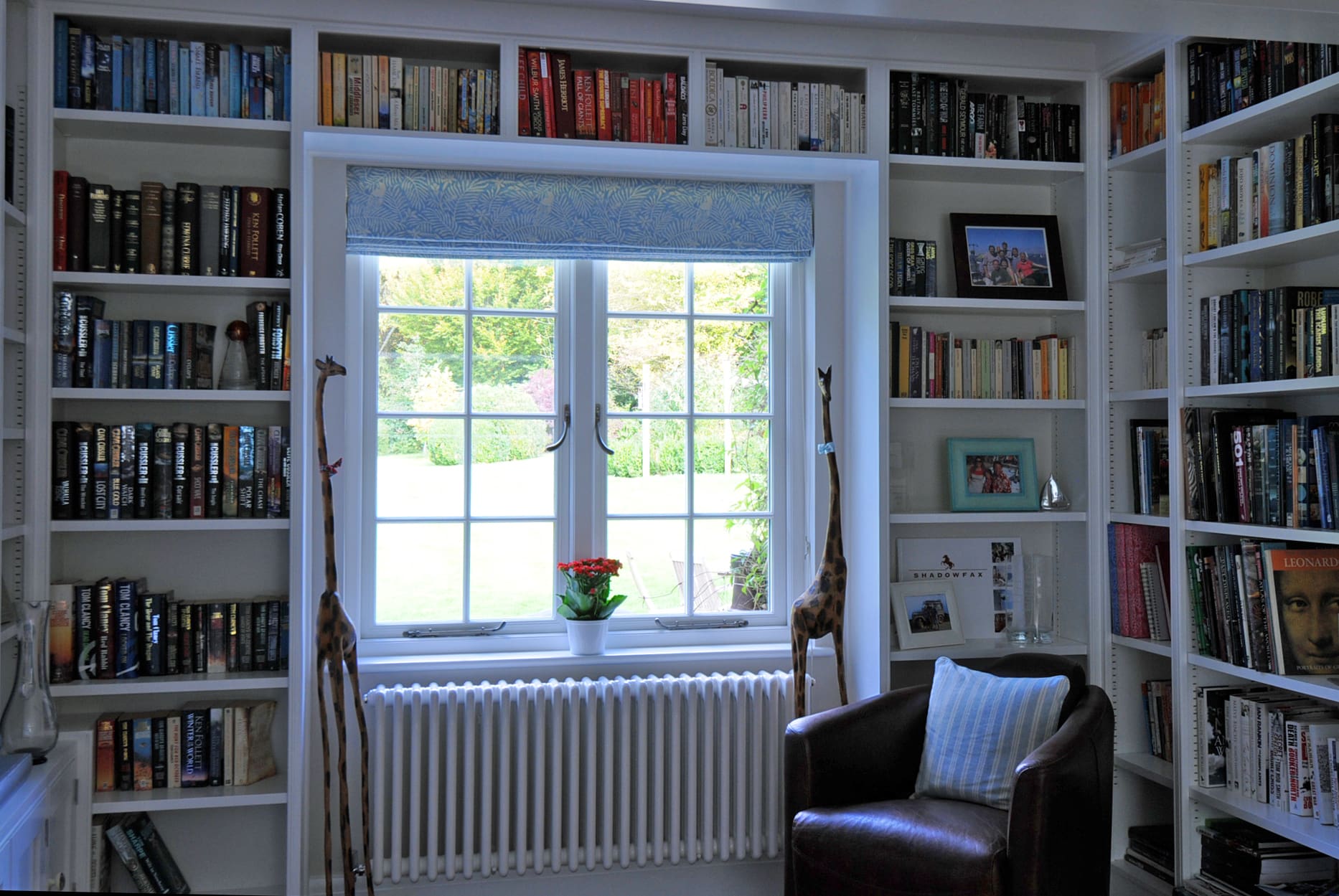 Traditional home interior with bookcases surrounding a traditional window.