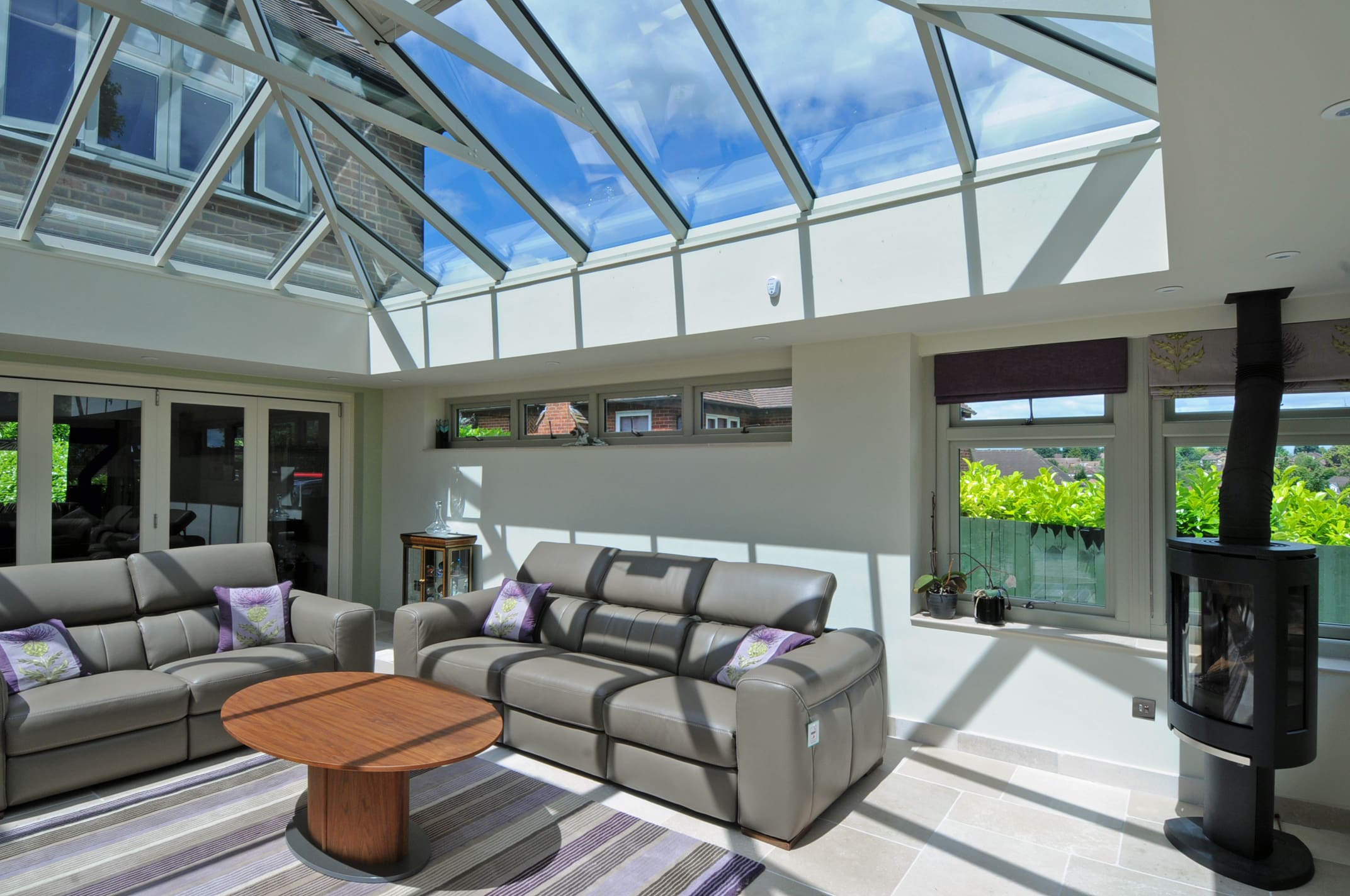 Beautiful lounge with large roof lantern and dual aspect windows and french doors.