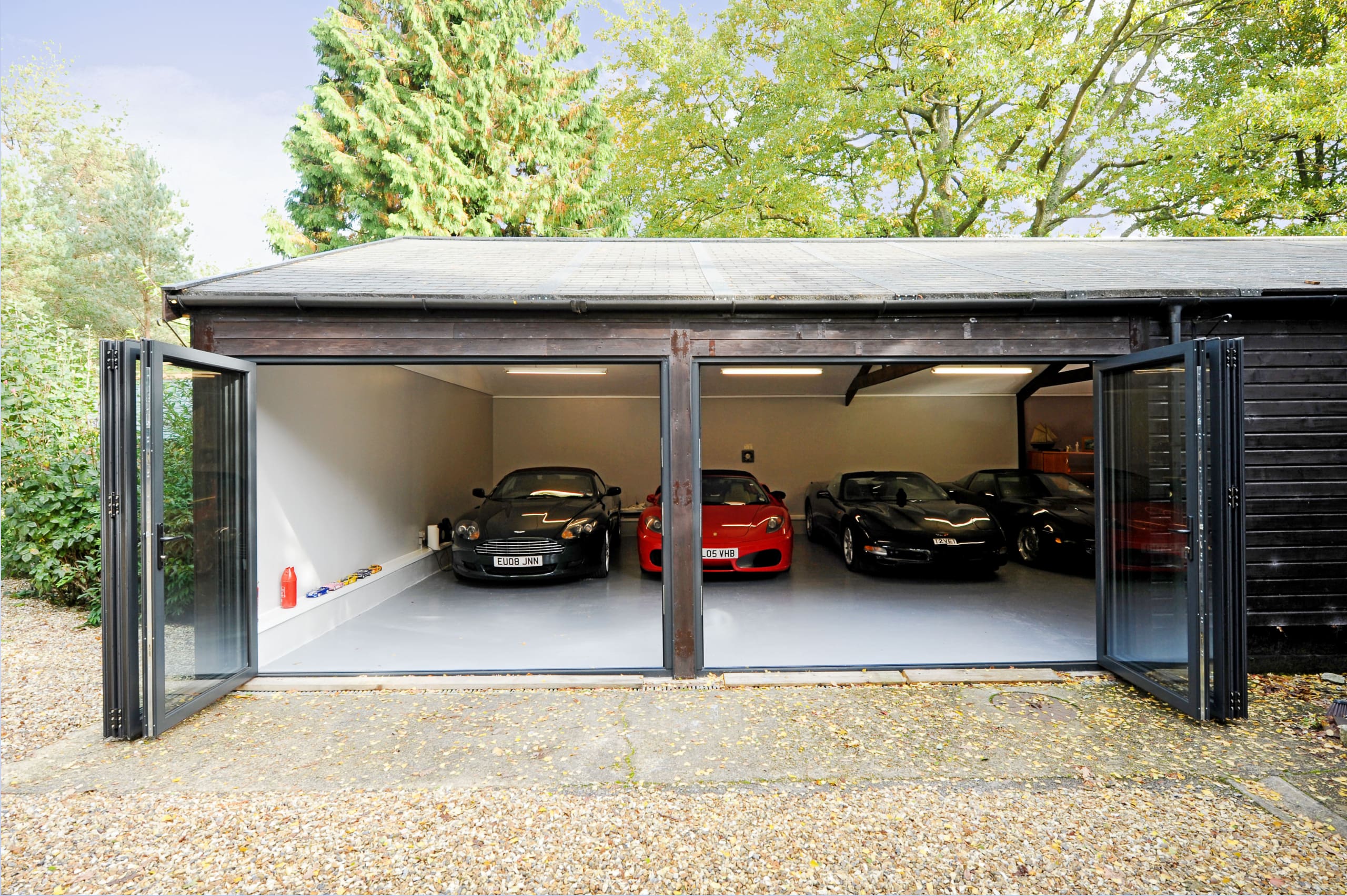 Garage housing super cars and bifolding doors.