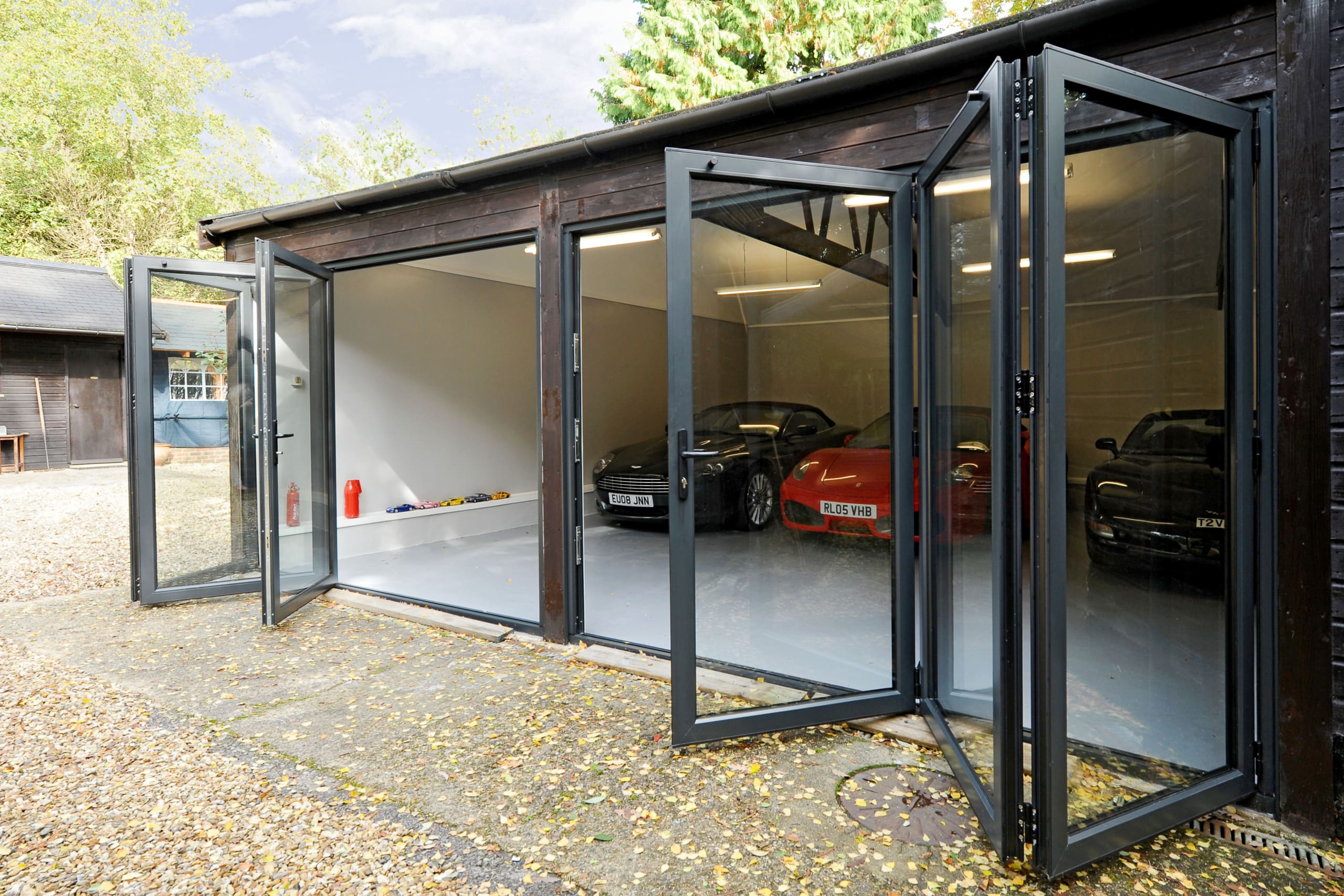 Garage housing super cars and bifolding doors.