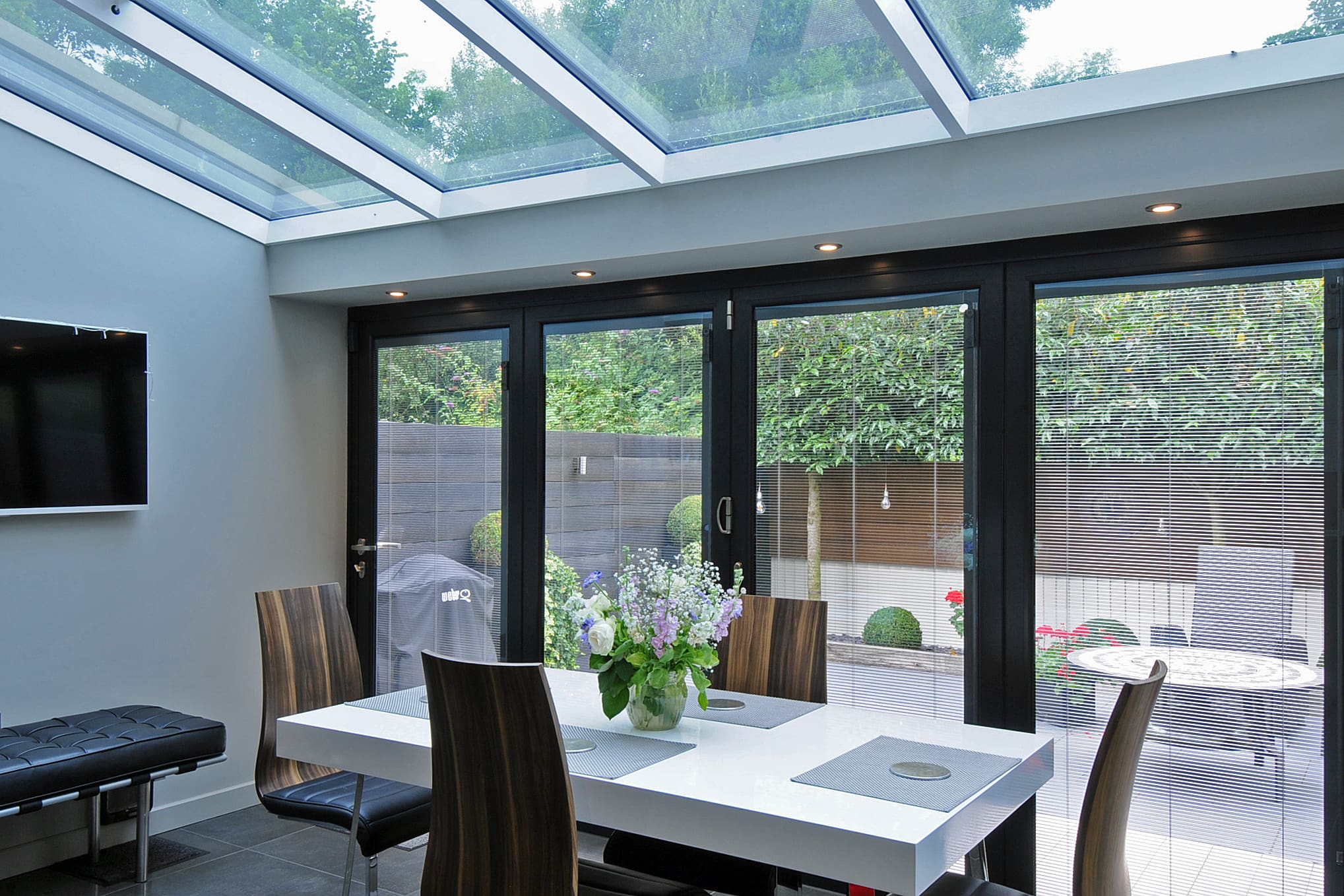 Dining room extension with bi-folding doors and bright roof light.