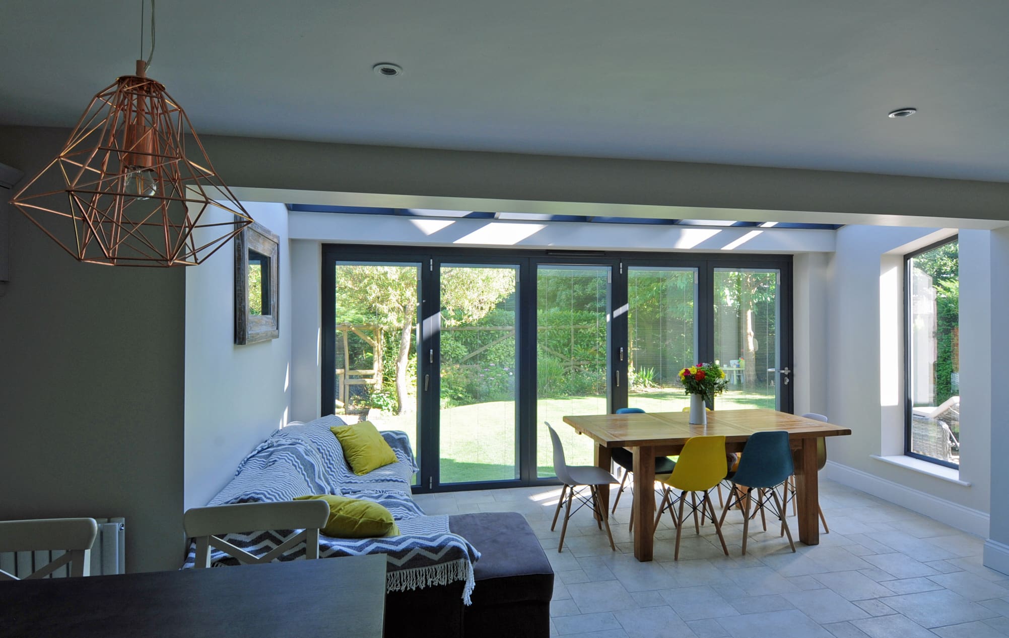 Modern dining room extension with roof lantern and bi-folding doors.