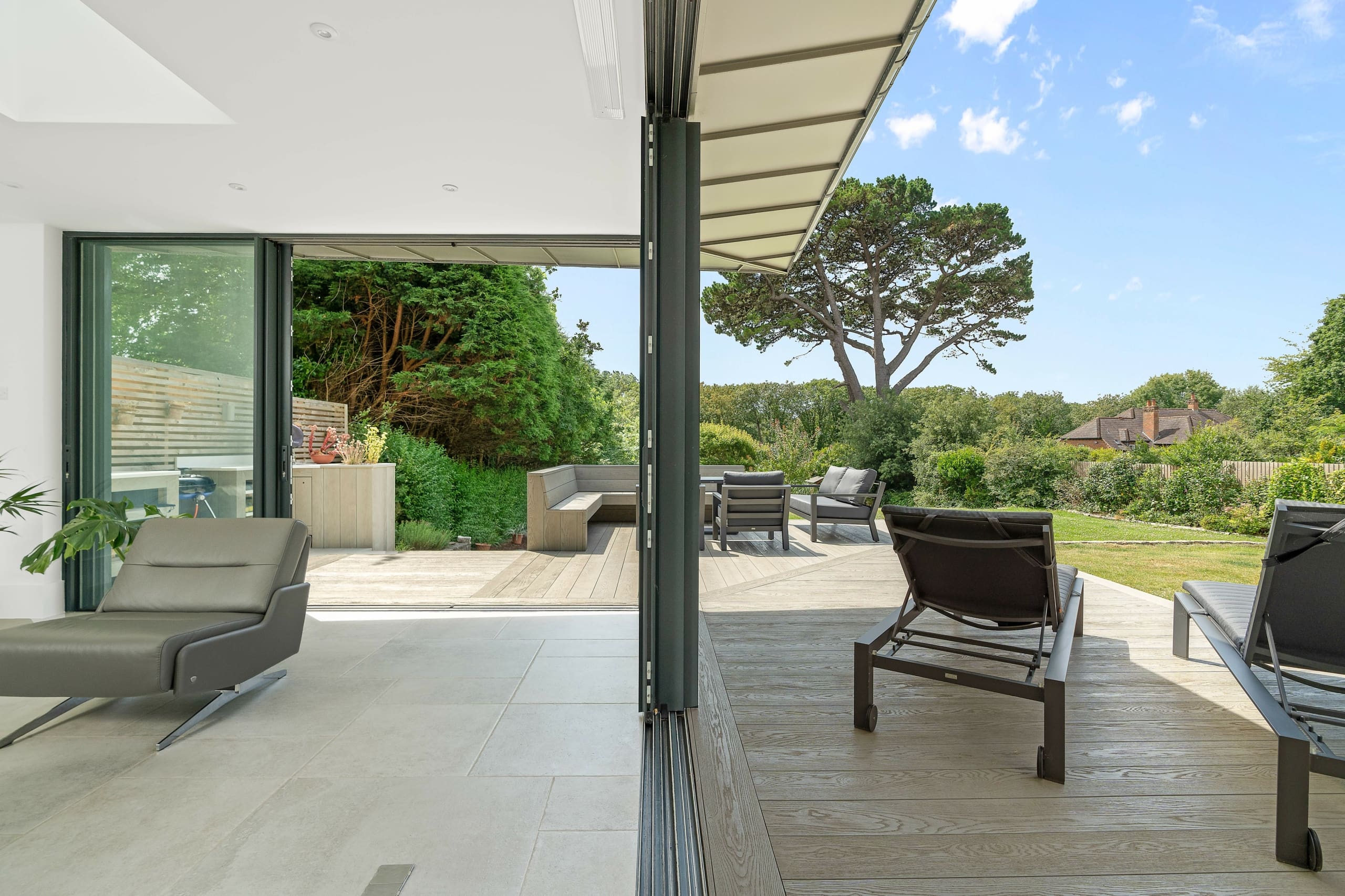Beautiful modern lounge overlooking a beautiful summers day with modern glazed alumnium sliding doors.