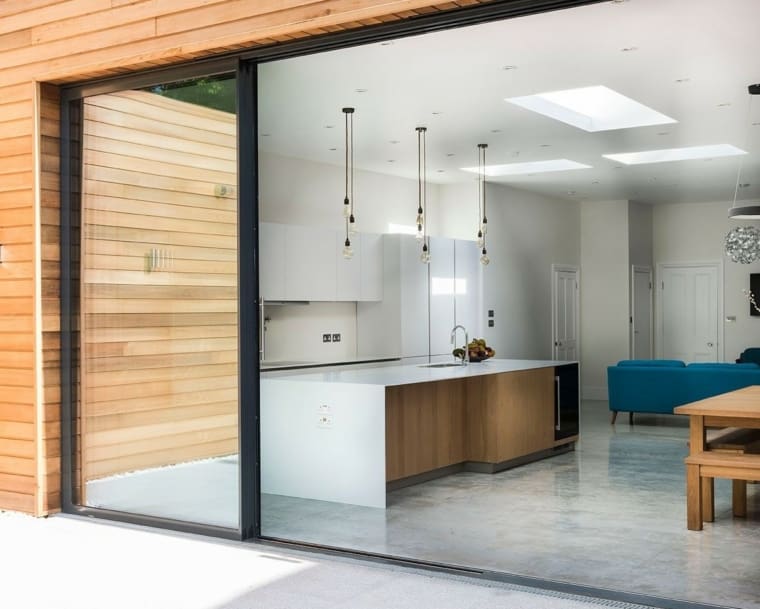 Stunning modern home kitchen extension with sliding glass doors.