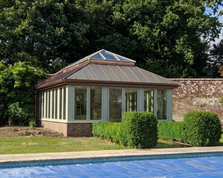 Poolside Orangery finished with olive green framework and a rooflantern.
