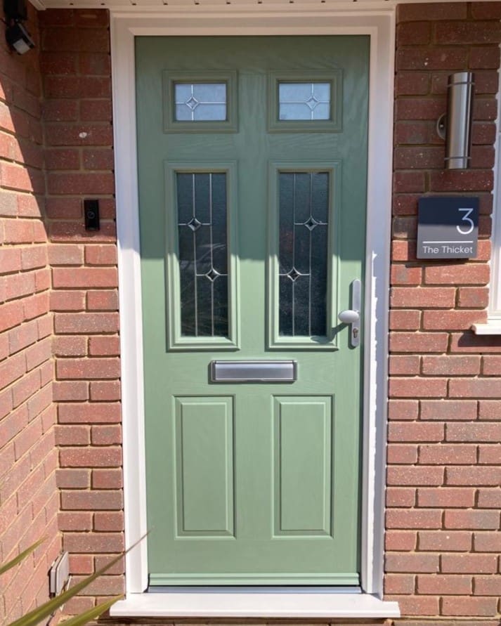 Traditional composite front door in olive green colour with silver finishing.