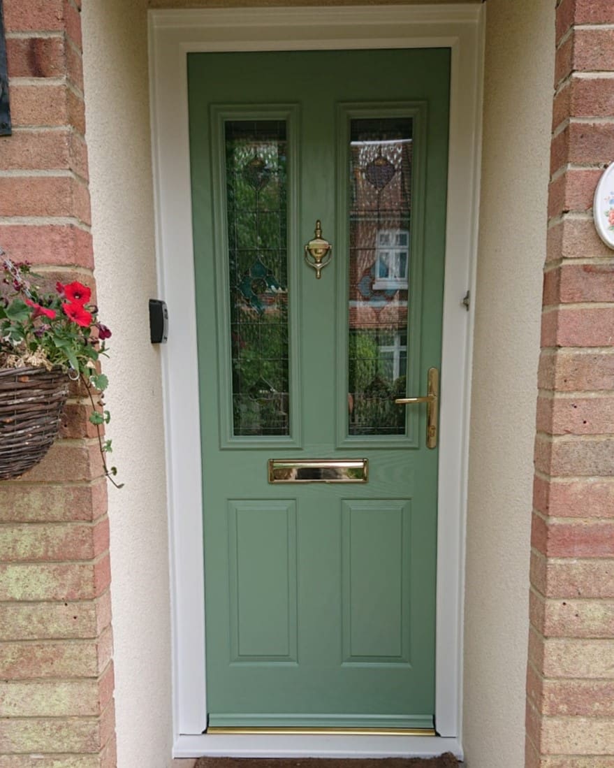 Traditional composite front door in olive green colour with gold finishing.